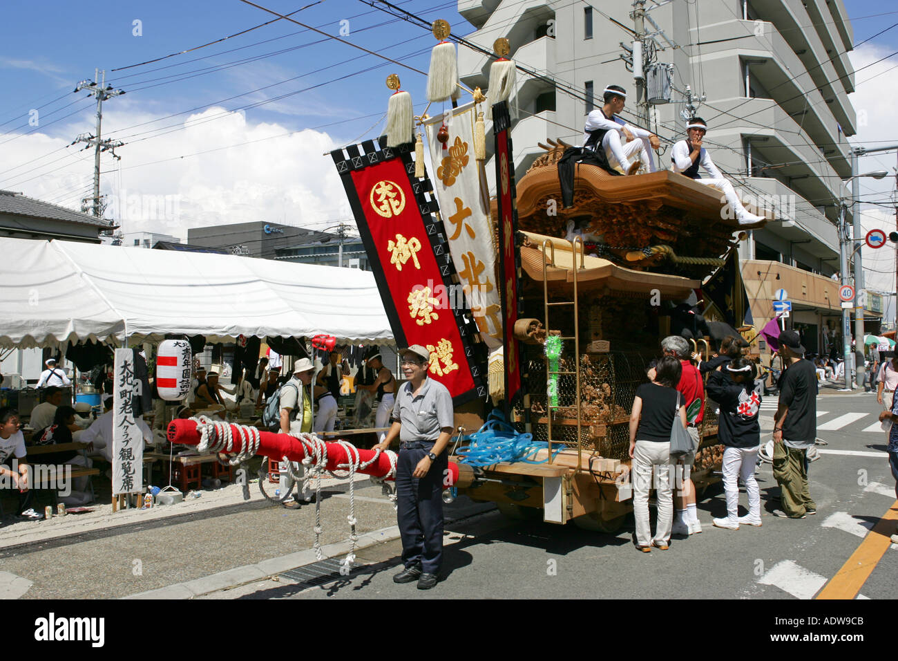 The brightly coloured advertising tapestries on the back of a kishiwada danjiri festival float Osaka Japan Asia Stock Photo
