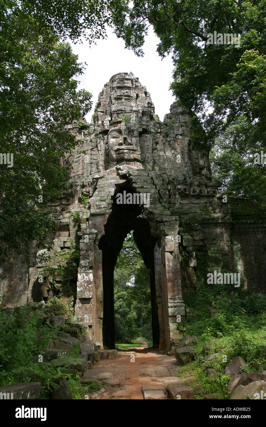 Ancient stone archway with face sculpture on top on a jungle path near ...