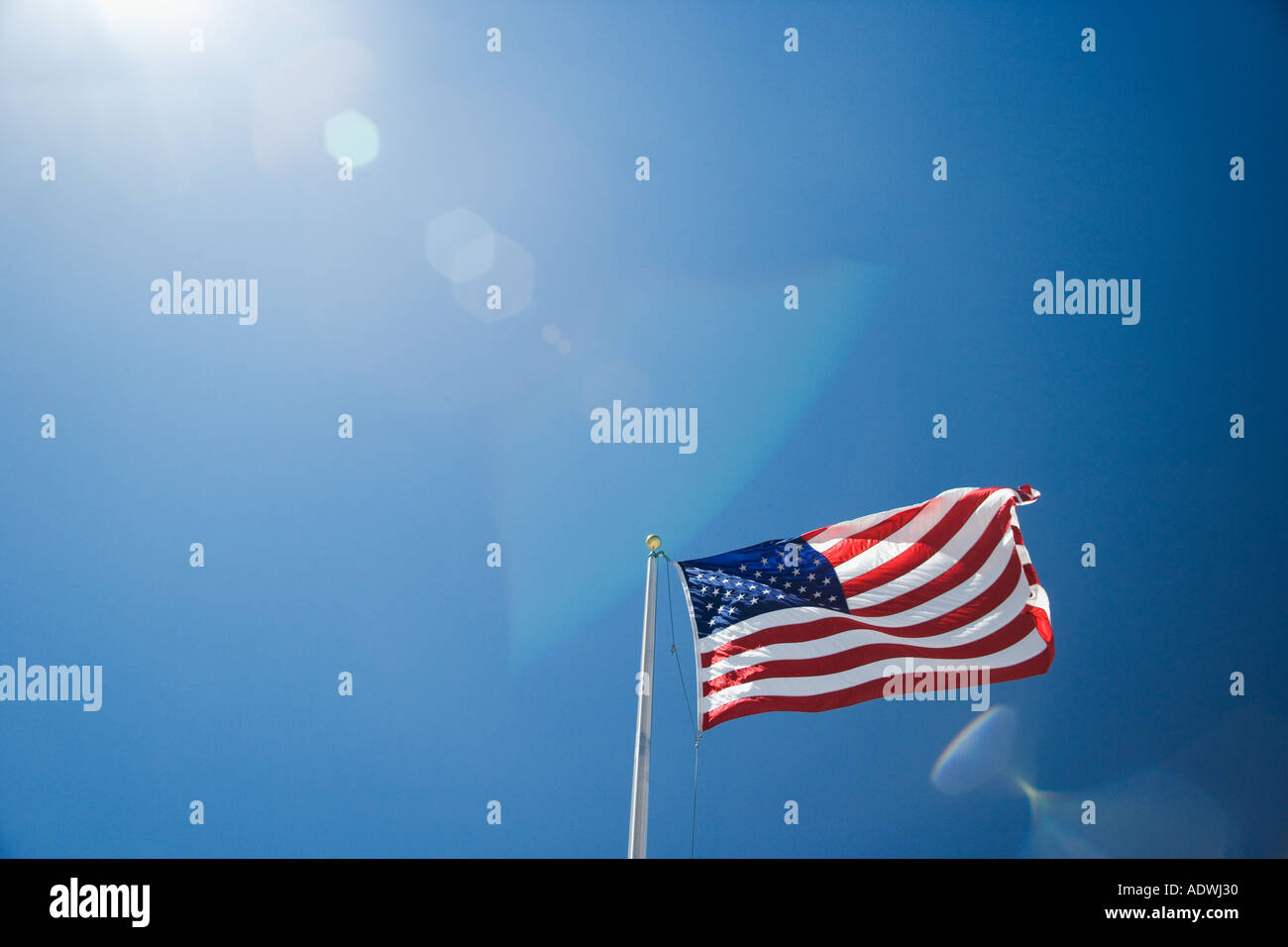 US flag against blue sky Stock Photo - Alamy