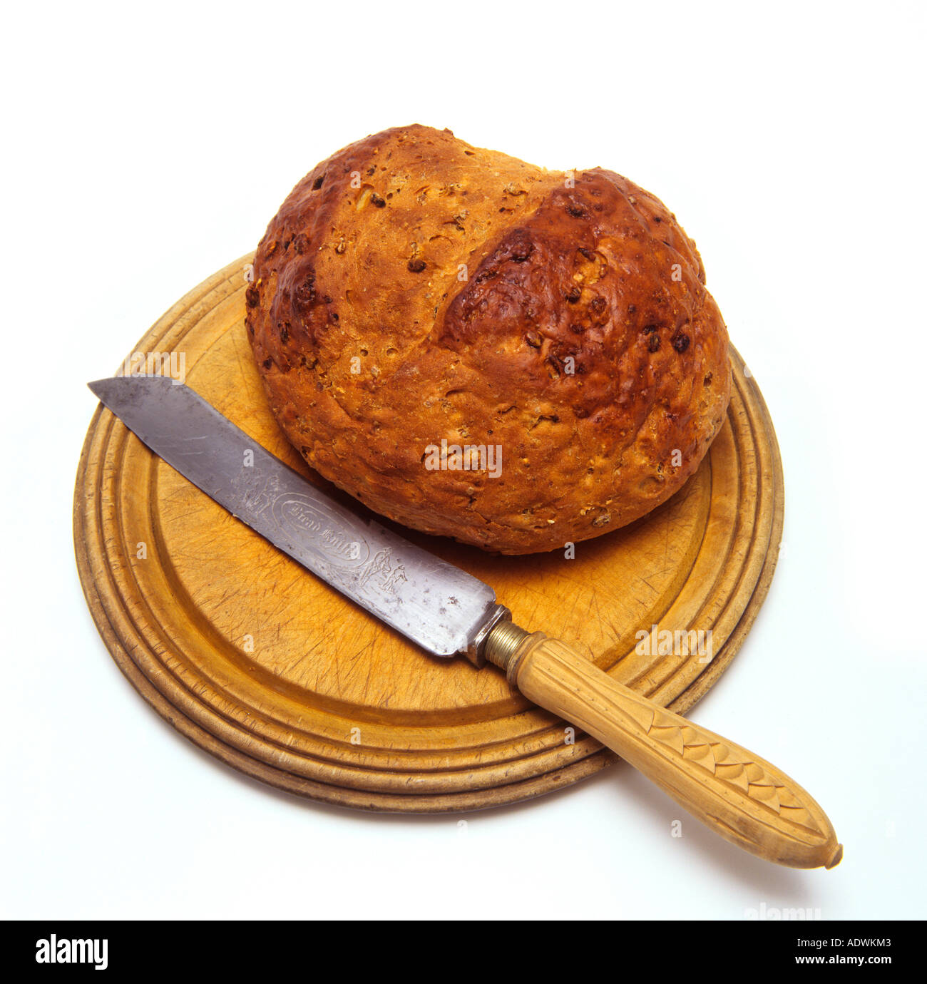 Food fresh Granary bread on breadboard with knife Stock Photo