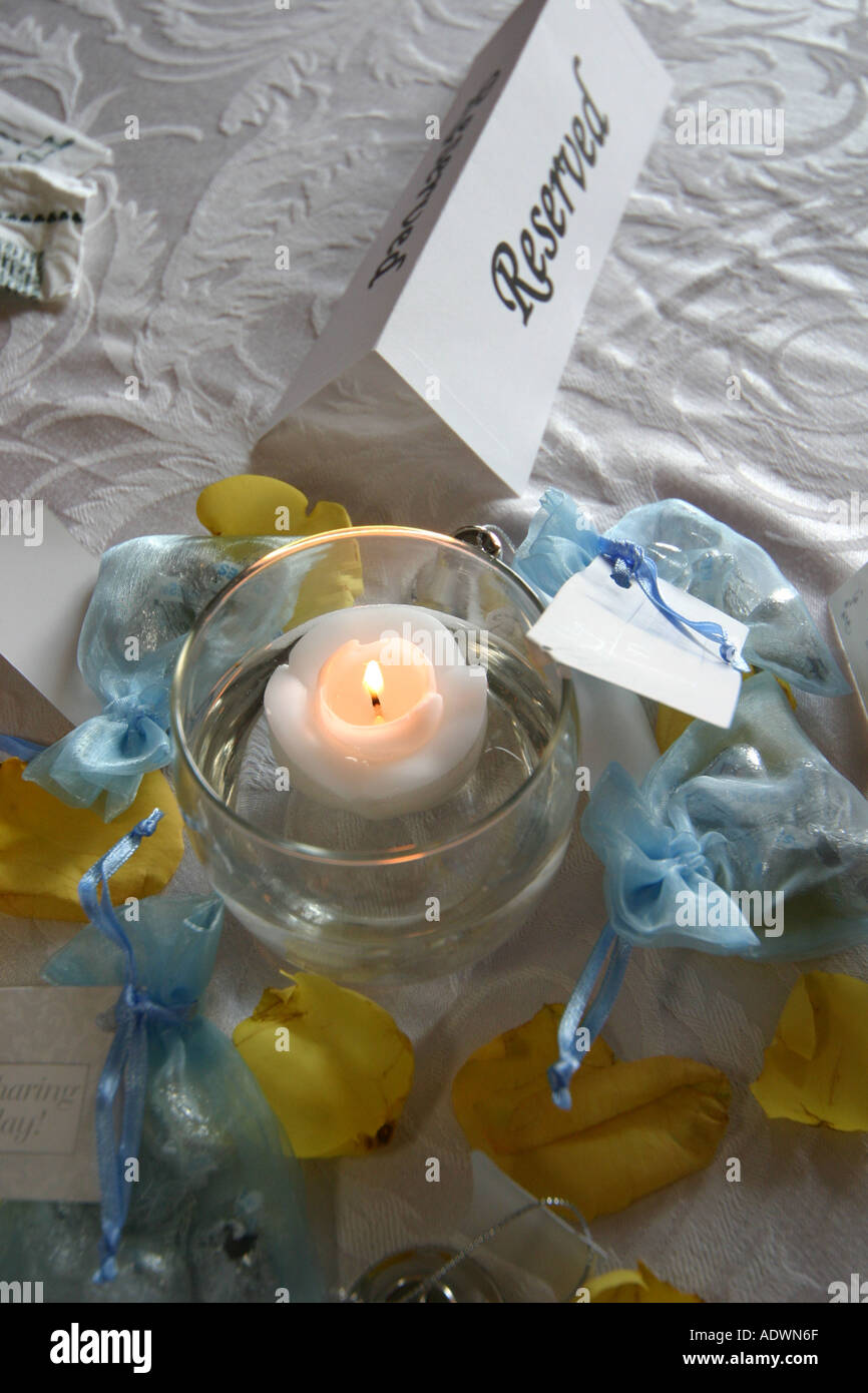 A Reserved Sign And A Floating Candle On A Table At A Wedding