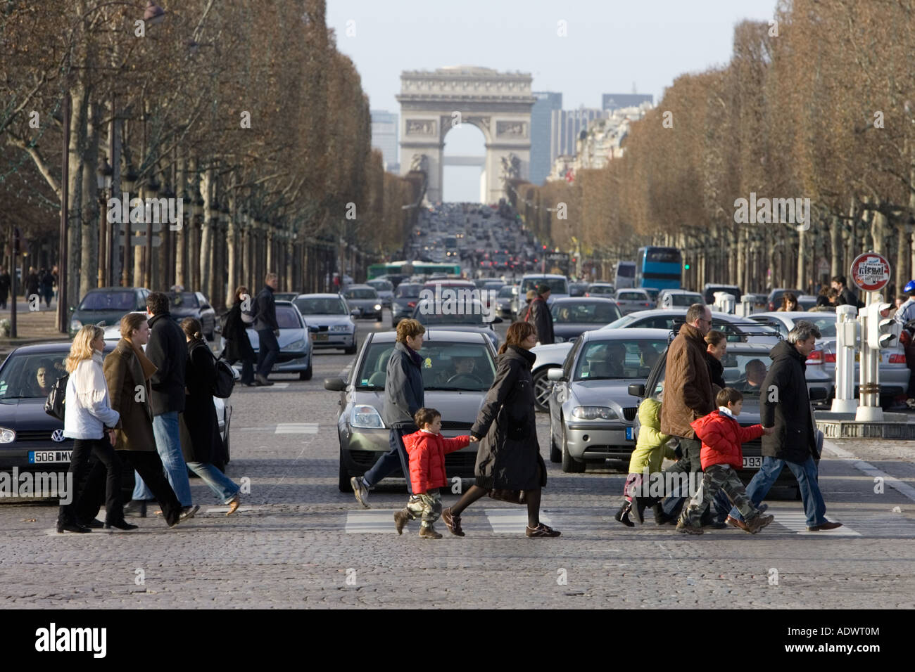 Traffic stops for pedestrians on zebra crossing across Champs Elysees in front of the Arc de Triomphe Central Paris France Stock Photo