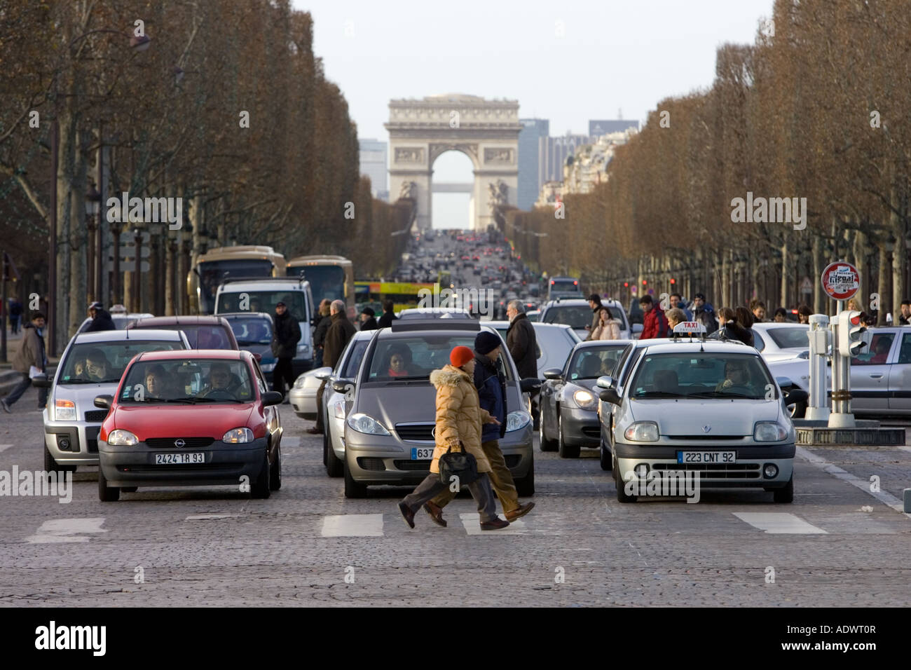 Traffic stops for pedestrians walking on zebra crossing on Champs