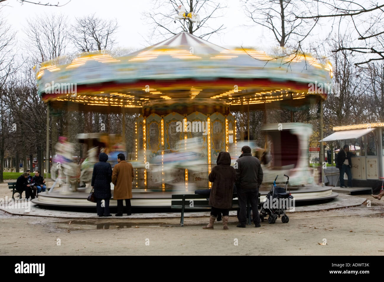 Parents watch their children on the carousel in Jardin des Tuileries Central Paris France Stock Photo