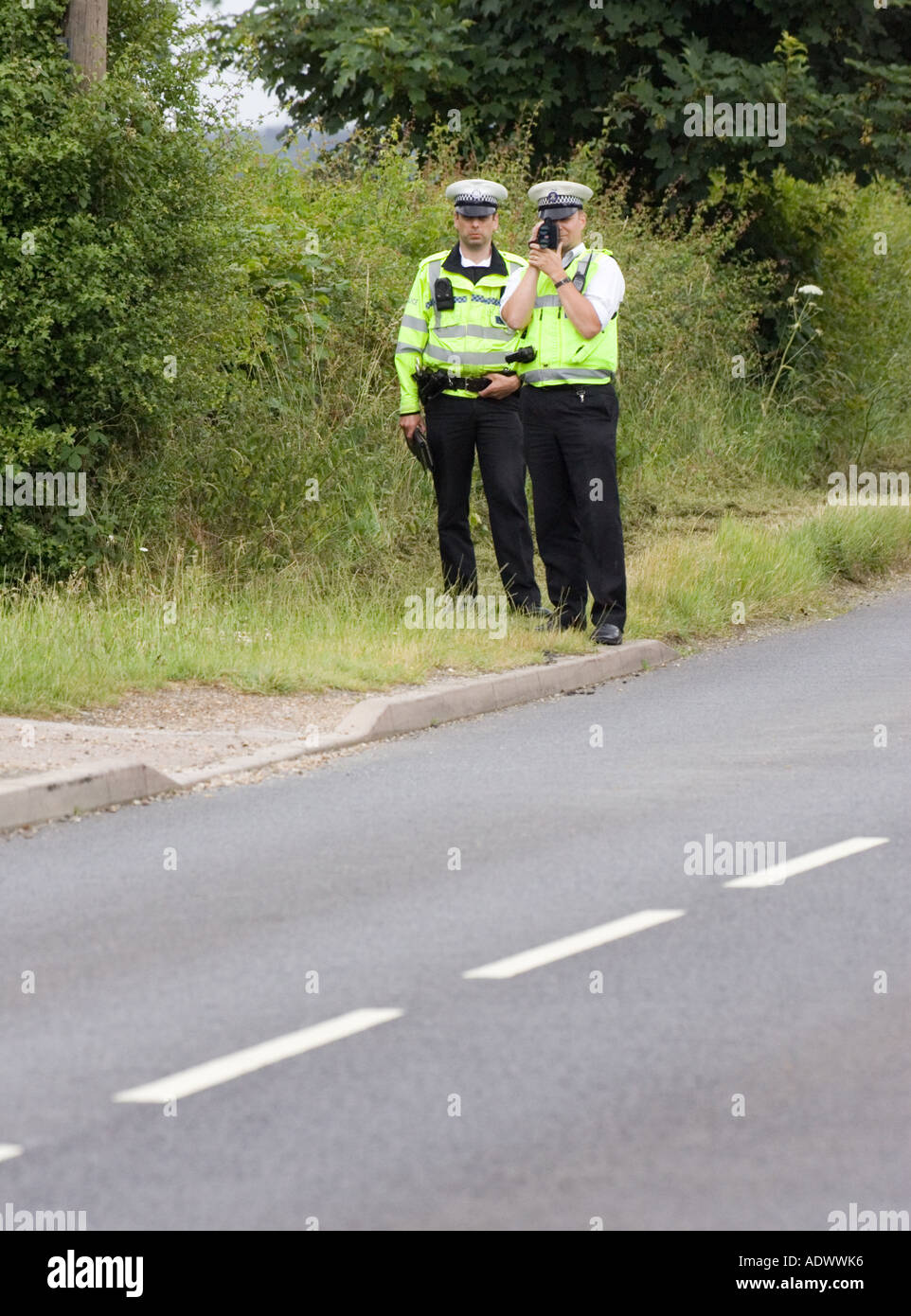 Police officers with a hand held laser speed camera detector Stock Photo