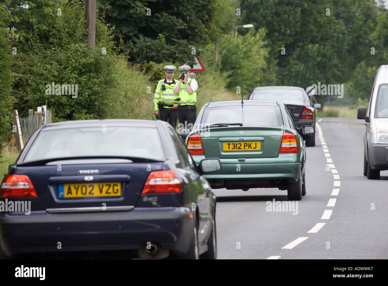 Police officers with a hand held laser speed camera detector in the UK Stock Photo