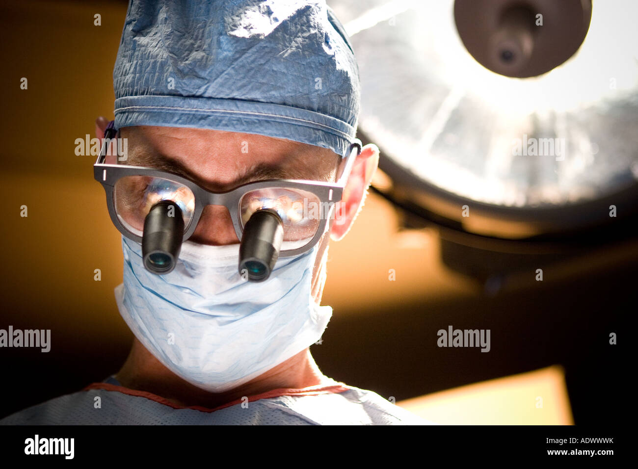 close up or tight portrait of a vascular surgeon performing a medical ...