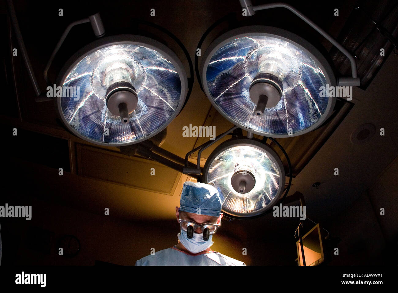 Looking upward at vascular surgeon and operating room lights during a surgical procedure Stock