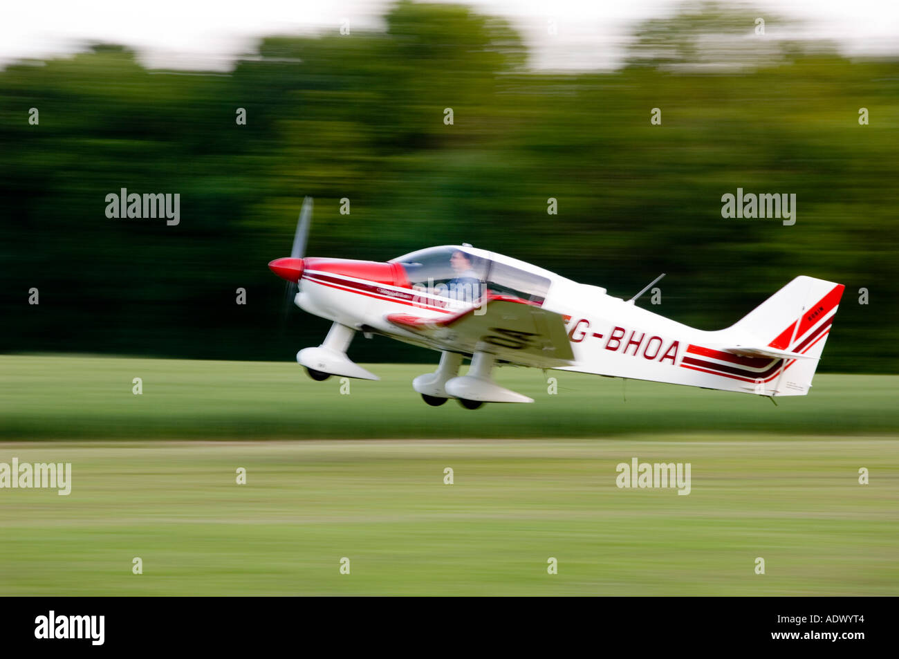Small single propeller light aeroplane, taking off from a small grass runway in Goudhurst, Kent. Stock Photo