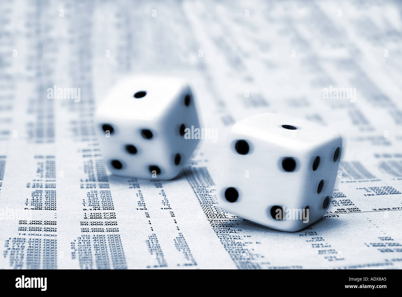 Business Concepts II holding dice die chance gambling bone bones throw luck roll newspaper finance page stock market bluish Stock Photo