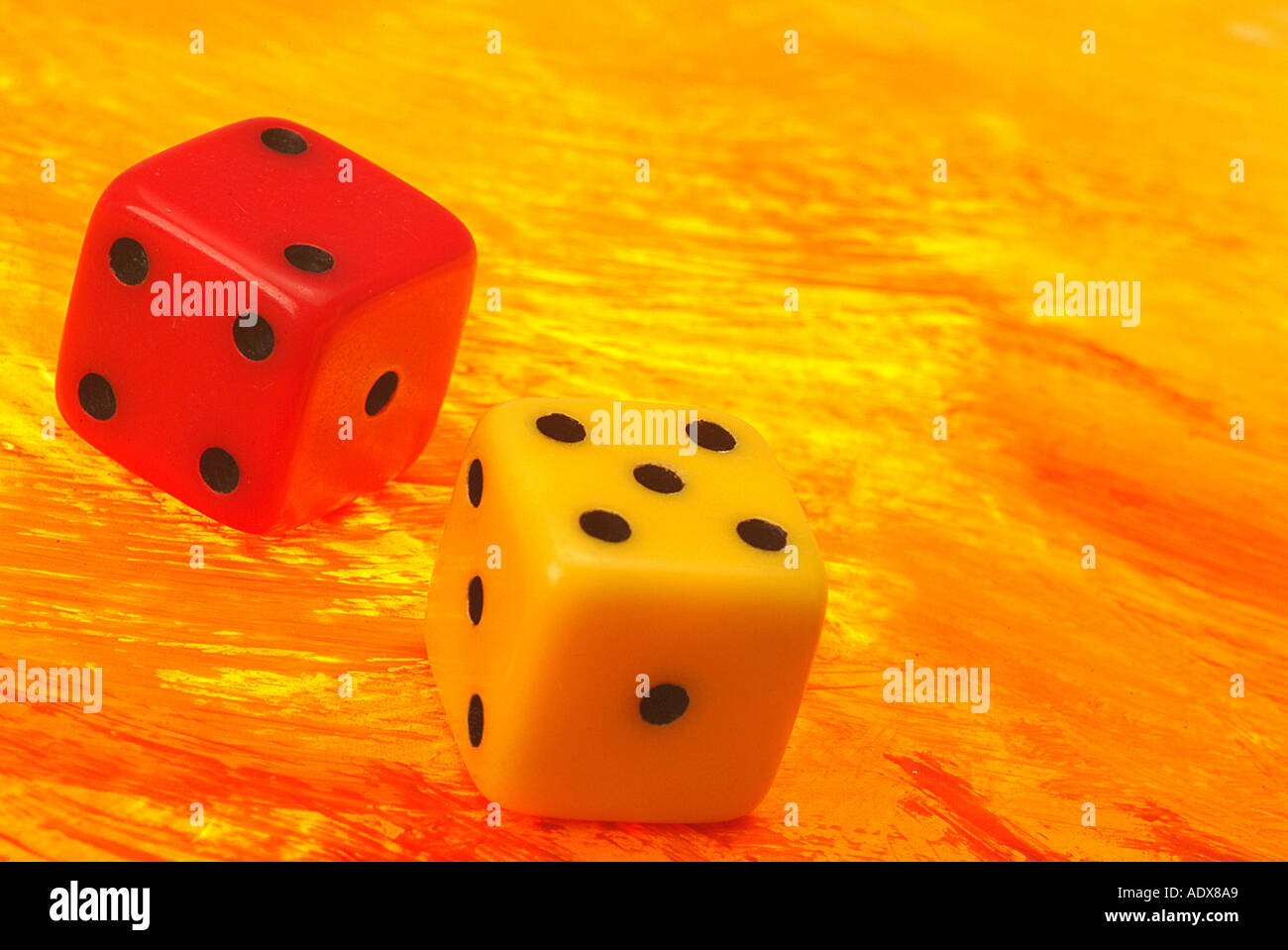 Business Concepts II holding dice die chance gambling bone bones throw luck roll stock market fiery reddish red yellow Stock Photo