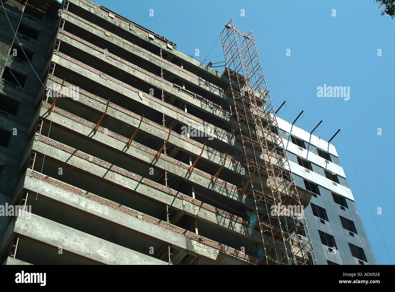 Architecture building tall hight scaffold construction block of flats storeys floors unfinished day daylight sunny cloudless Stock Photo