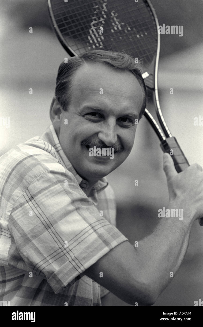 Mid age Man Playing Tennis Stock Photo