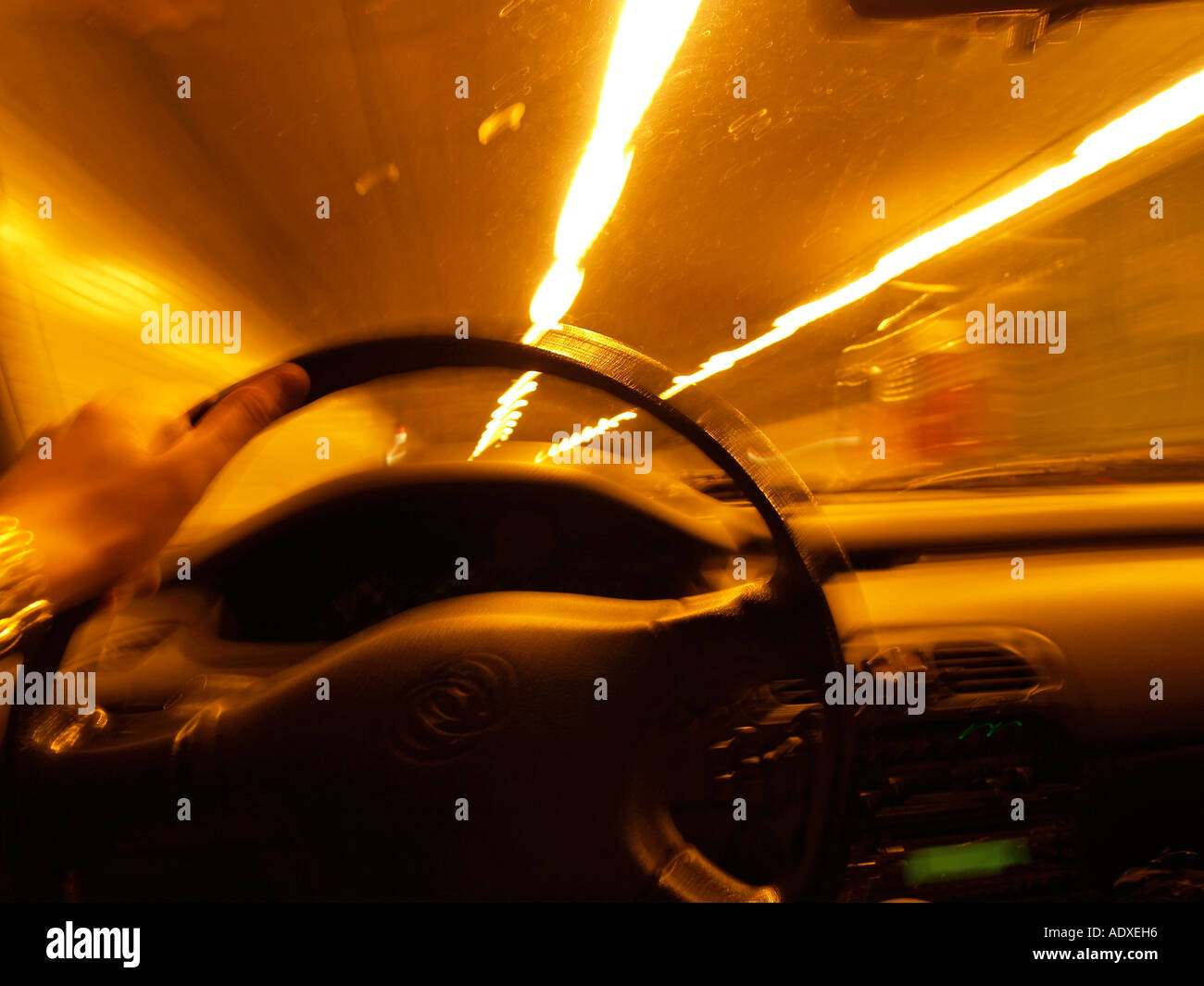 Driving in a tunnel with yellow artificial light drivers view Rotterdam