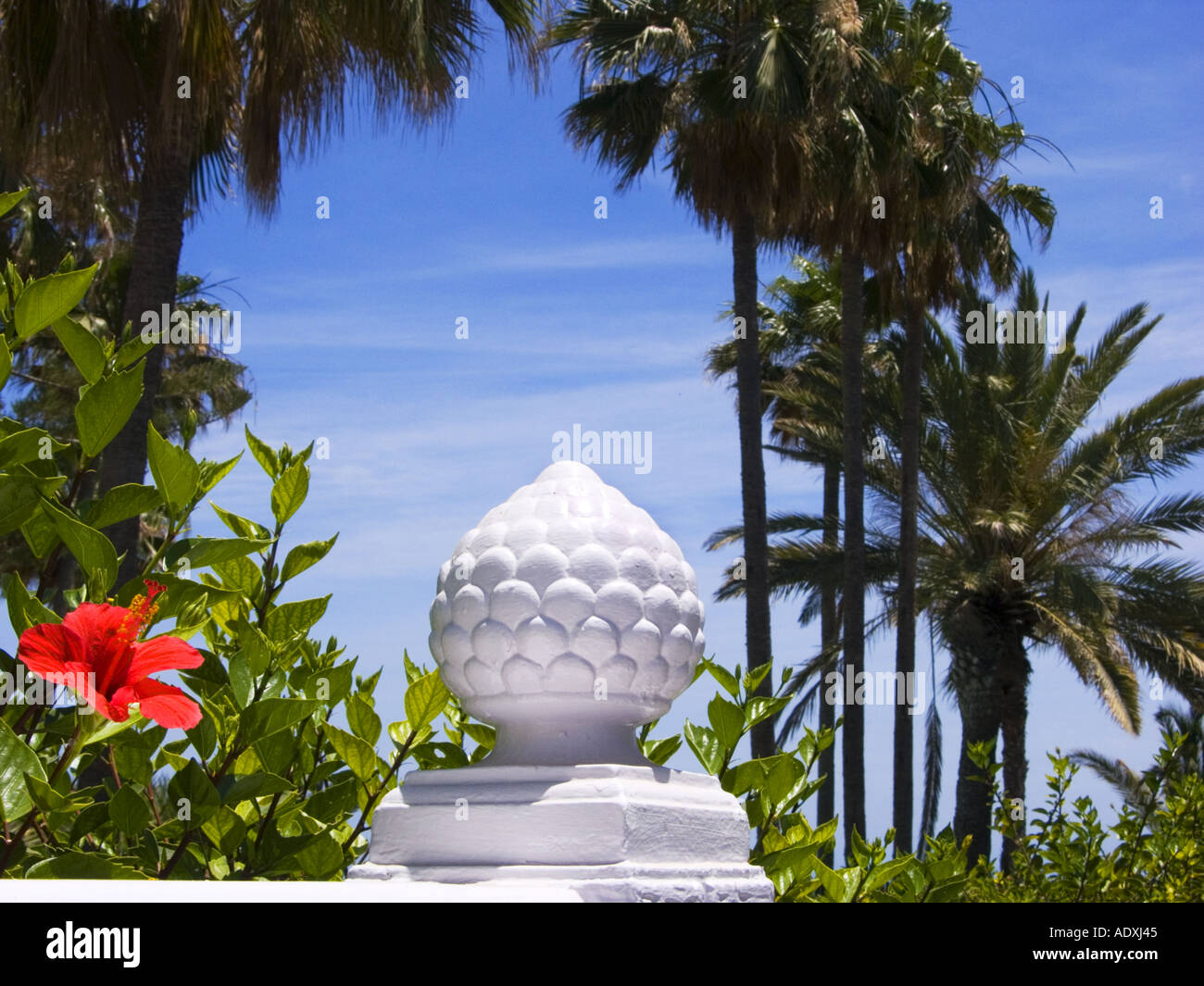hotel Garden in MASPALOMAS PLAYA DEL INGLES Gran Canary flower red monument stone marble palm  Stock Photo