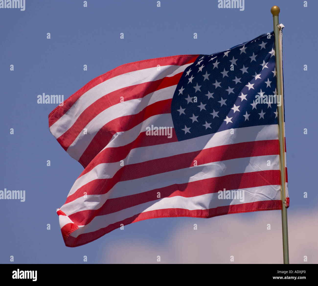 American flag against a blue sky Stock Photo - Alamy
