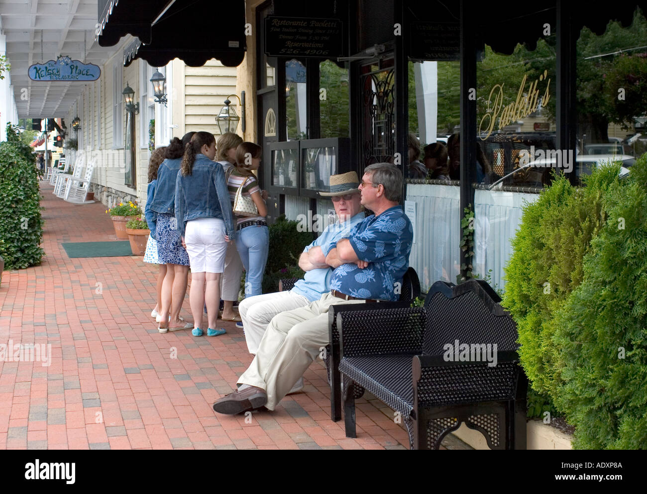 Men Resting On Bench Outside Clothing Store Highlands Nc Stock