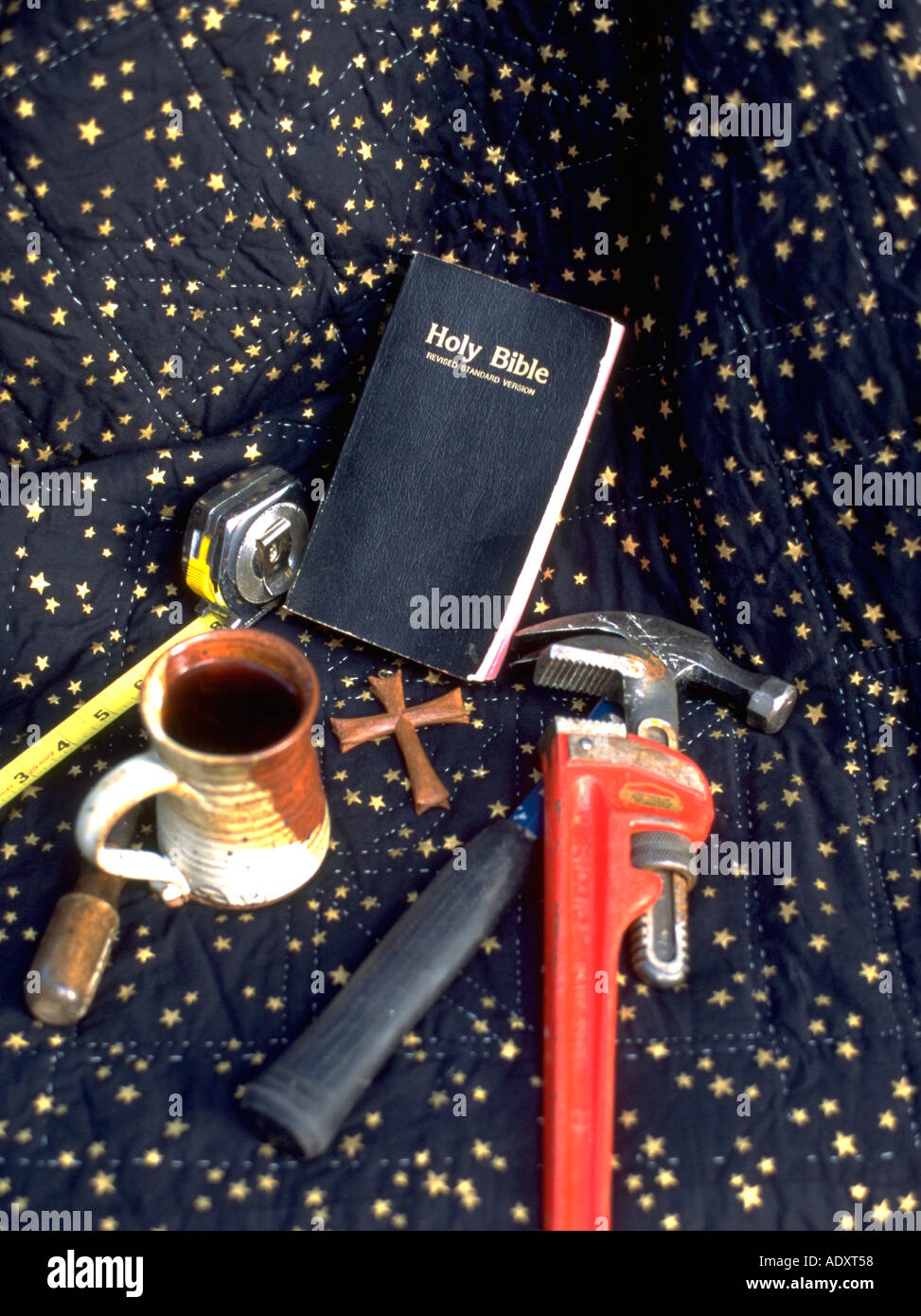 Repairman's tools Bible cross mug wrench tape measure screwdriver and