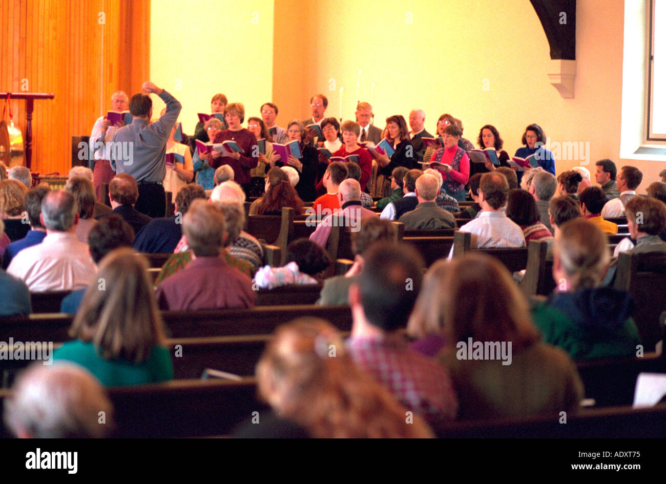 Choir director leading singing of congregates at church service. St Paul Minnesota USA Stock