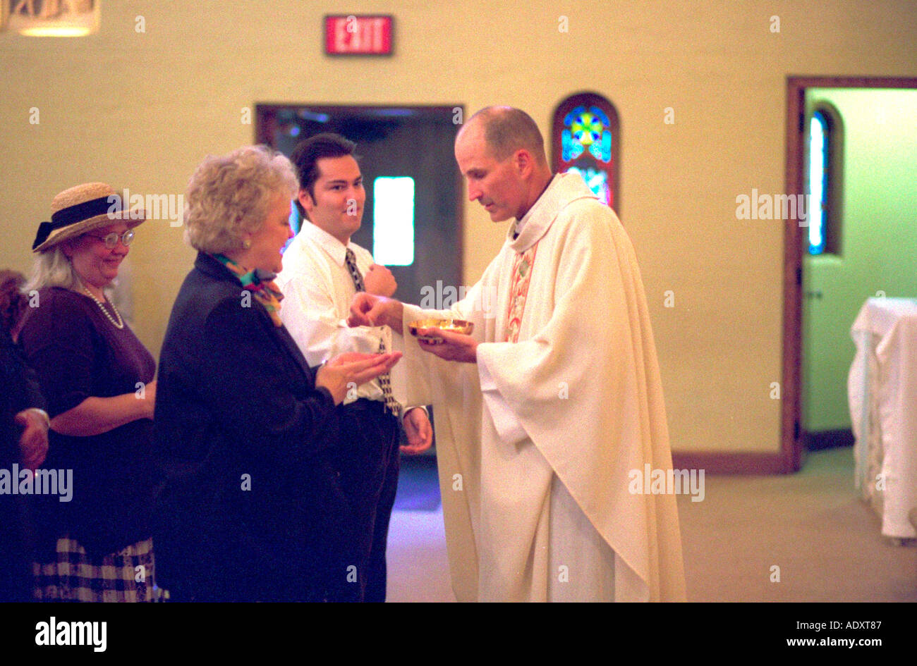 Catholic priest performing Eucharist at wedding service. St Paul Minnesota USA Stock Photo