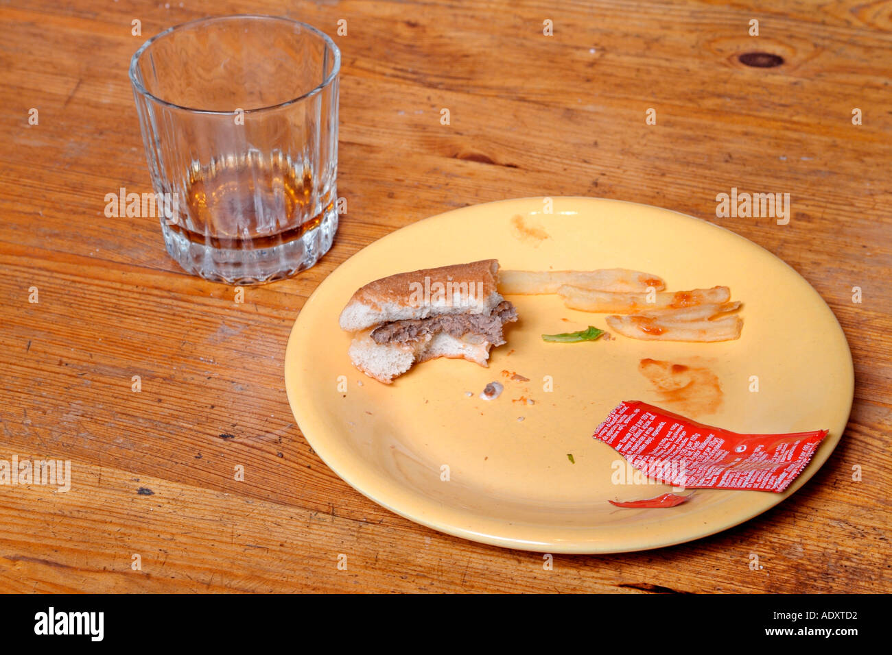 Leftovers from a fast-food burger meal. Stock Photo