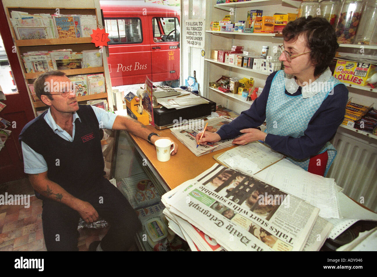 Post Bus driver with Post Mistress at a small rural post office near Aberystwyth Ceredigion Wales UK Stock Photo