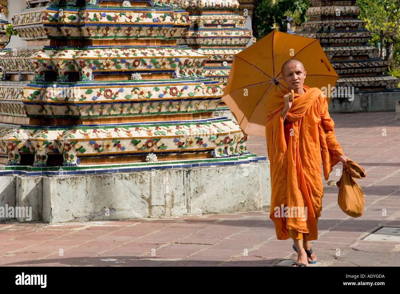 Buddhist monk with parasol umbrella in the grounds of Wat Po Bangkok Stock Photo Alamy