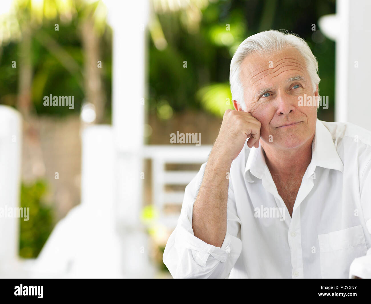Man sitting on verandah, portrait Stock Photo