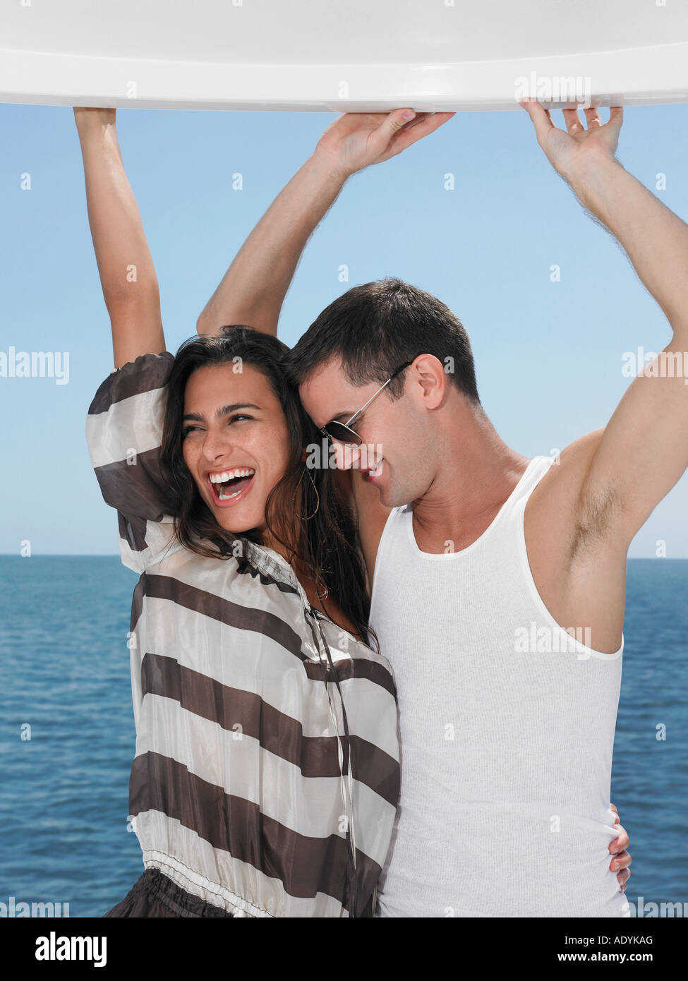 Young couple dancing, sea in background Stock Photo