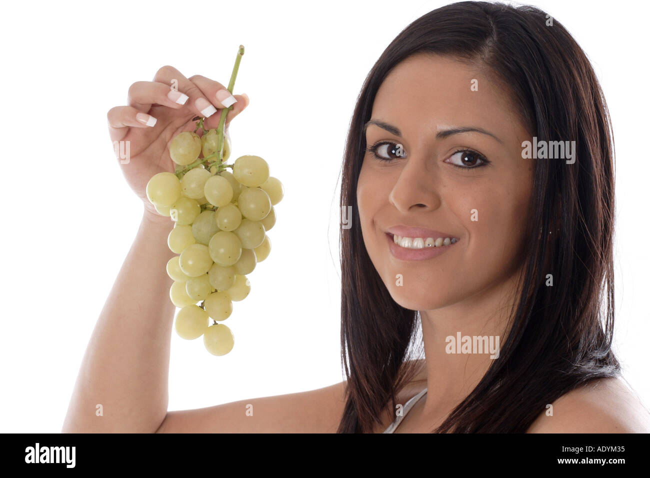 black-haired young woman holding grapes. Stock Photo