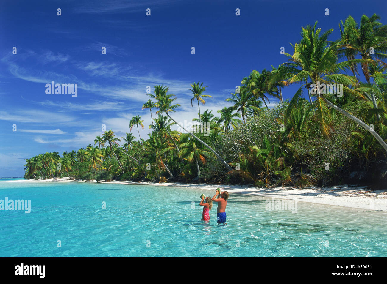Couple drinking coconut milk at One Foot Island in Aitutaki Island