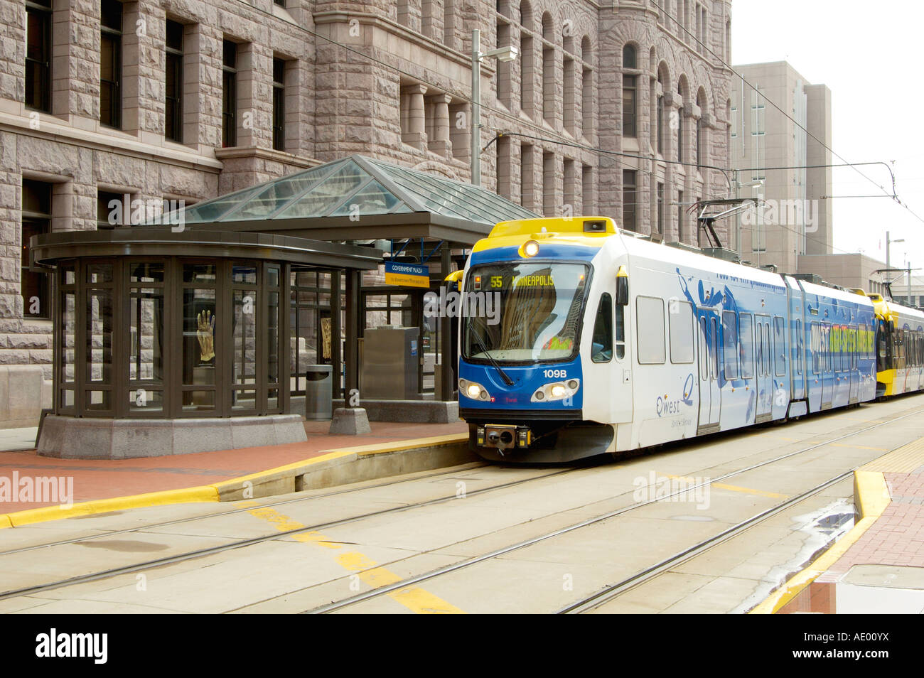 a light rail mass transit train in front of the government plaza