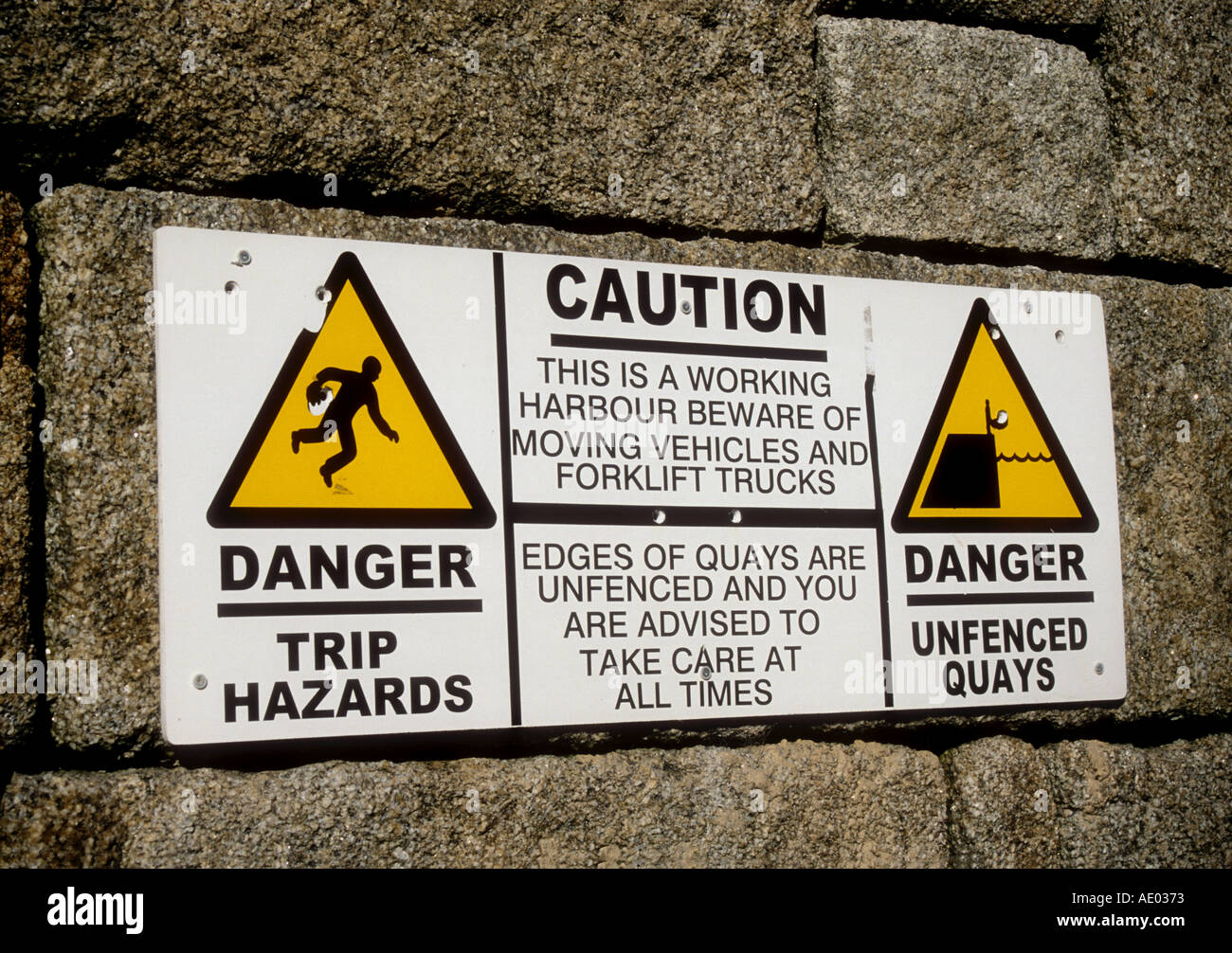 Caution notice on the sea wall at Hugh Town Quay St Marys Isles of Scilly England UK  Stock Photo