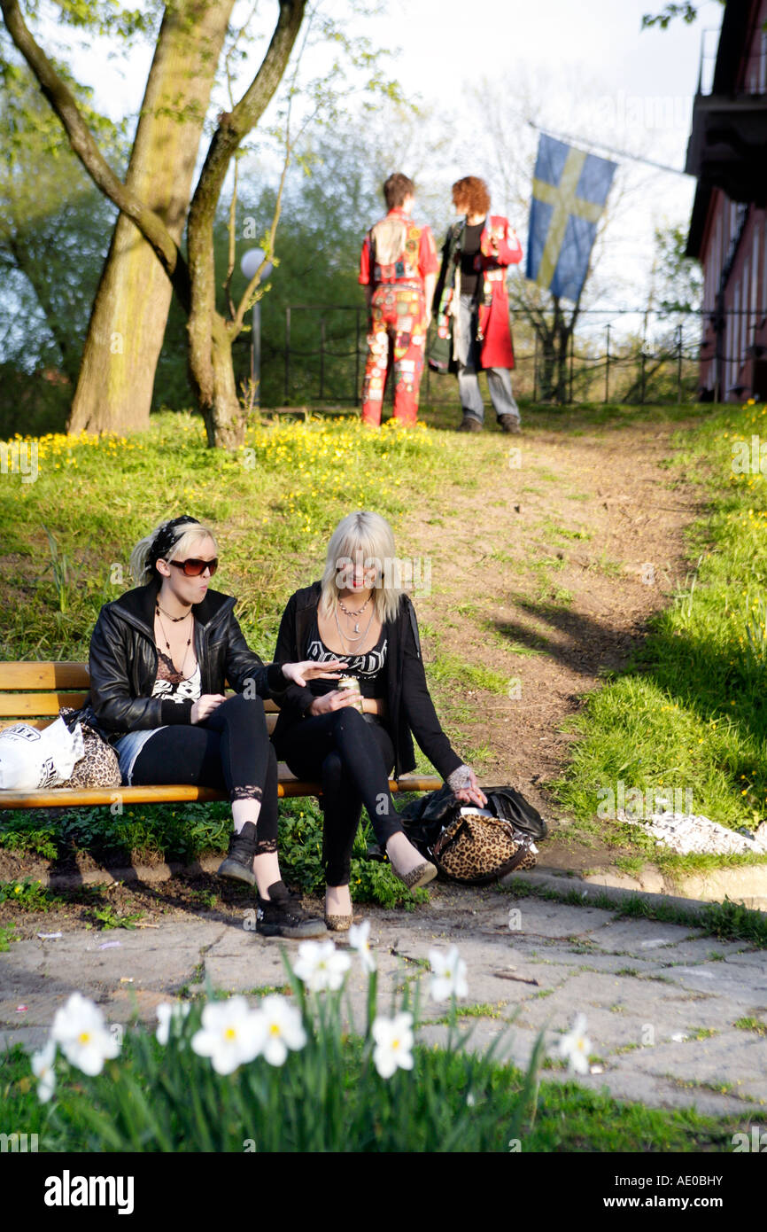 Two young Swedish women relaxing on a bench in a park in Gothenburg Sweden Stock Photo