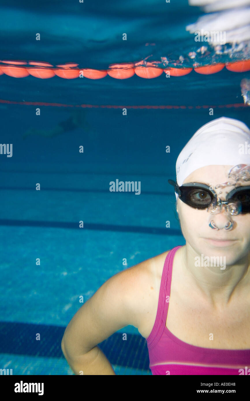 Water Sport Woman in Purple Swim Suit doing exercise underwater in a