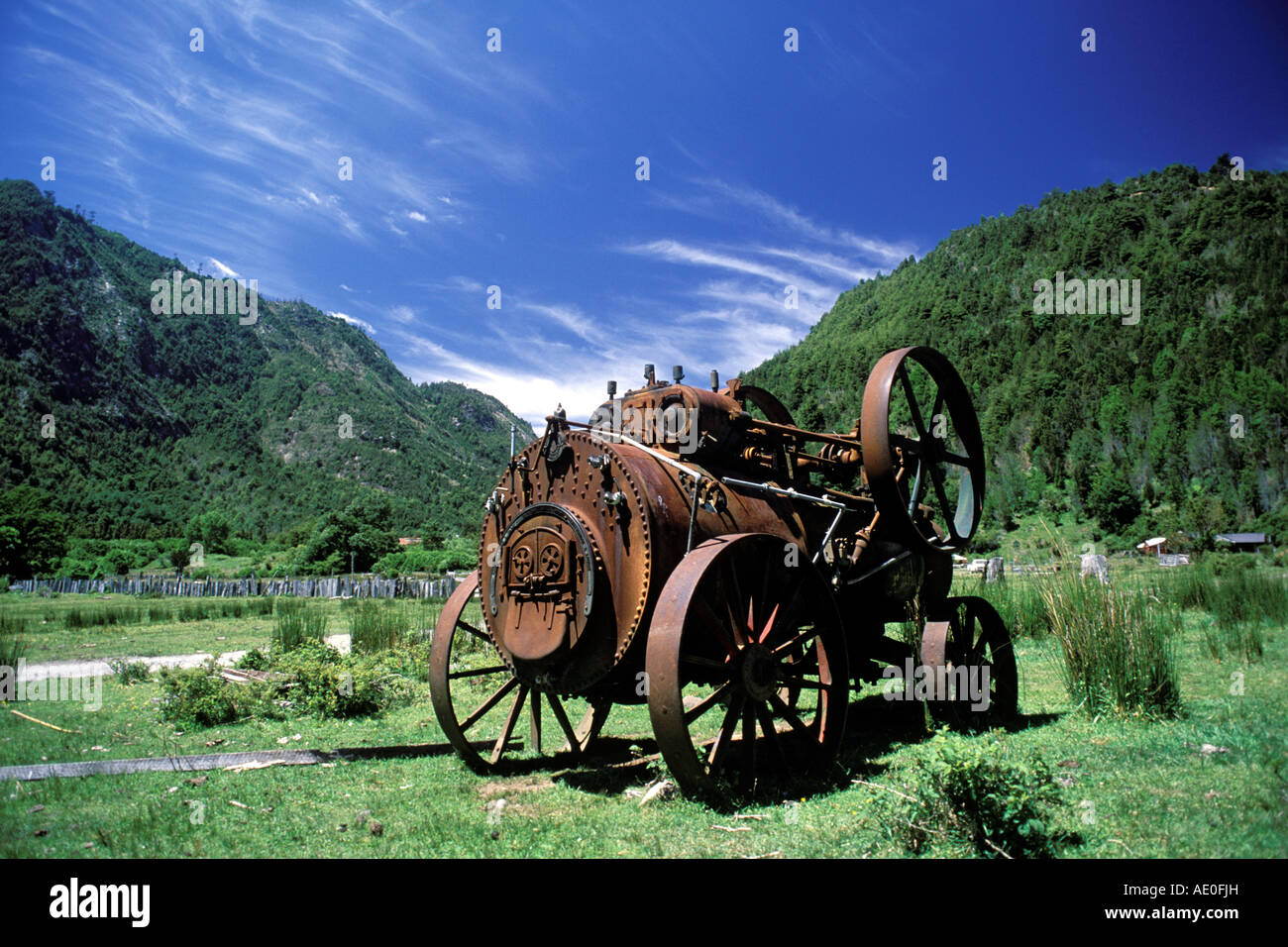 A19th Century British steam engine used to power farm equipment lies abandoned in a field in Chile, South America Stock Photo