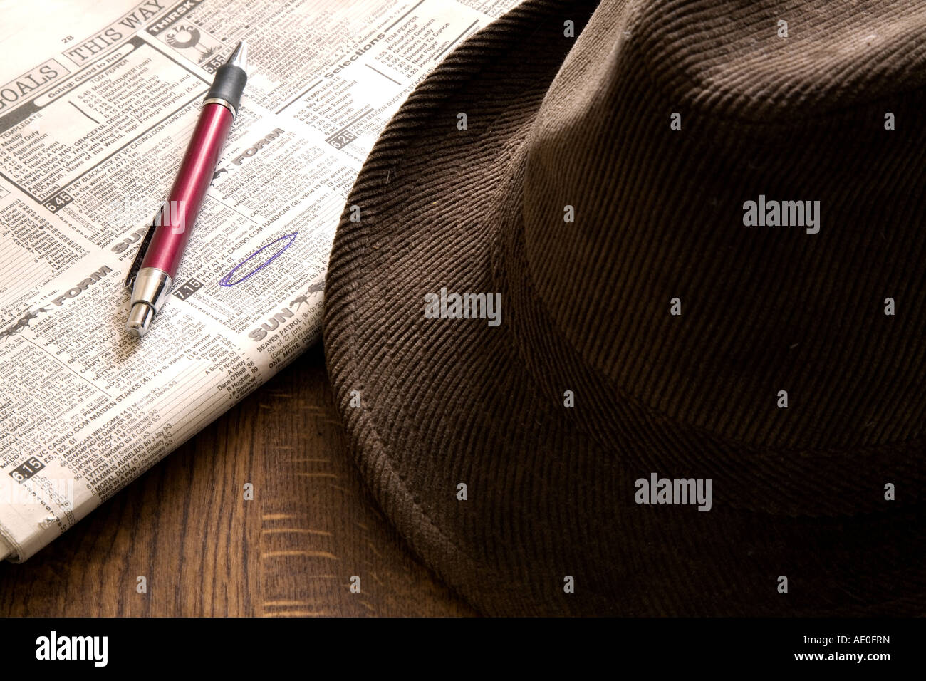 Brown hat newspaper and pen on the horse racing page Stock Photo