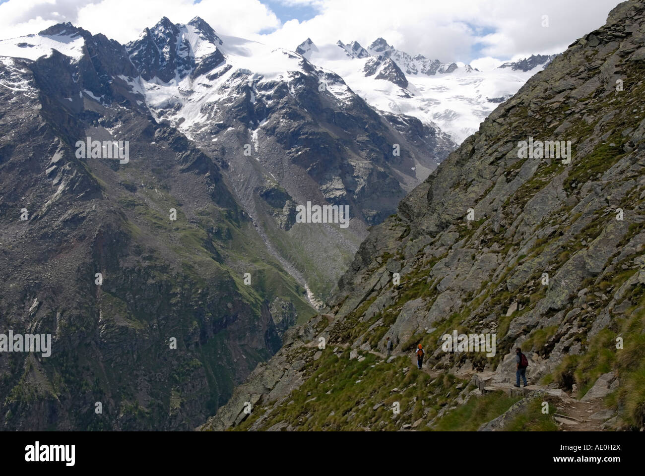 Hikers on a high altitude traverse, above treeline, Gran Paradiso National Park Stock Photo
