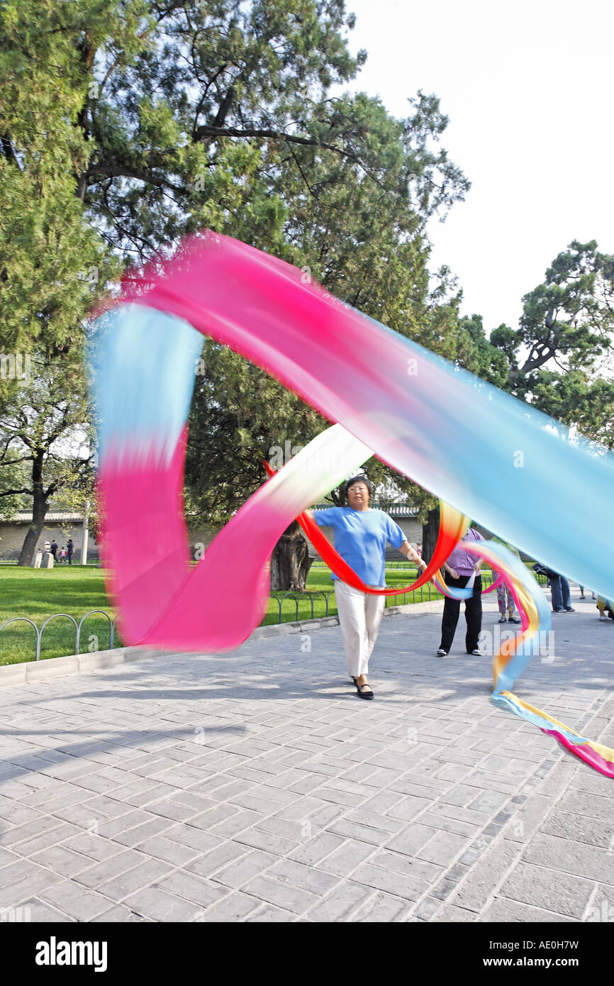 Woman swirling colorful silk scarves Temple of Heaven Park Beijing China Asia Stock Photo