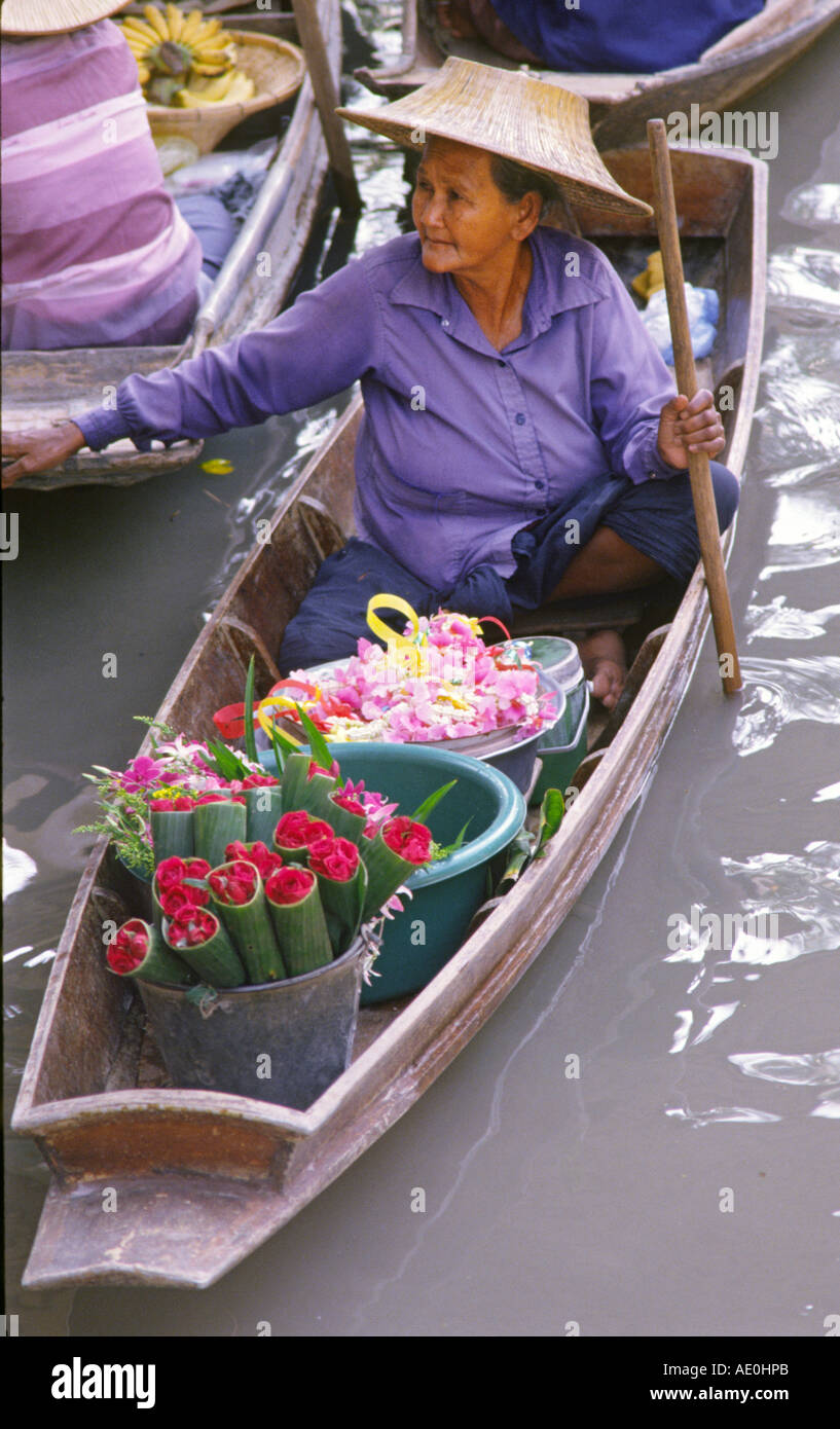 Woman selling flowers at Floating Market   Damnoen Saduak  BANGKOK Thailand Stock Photo