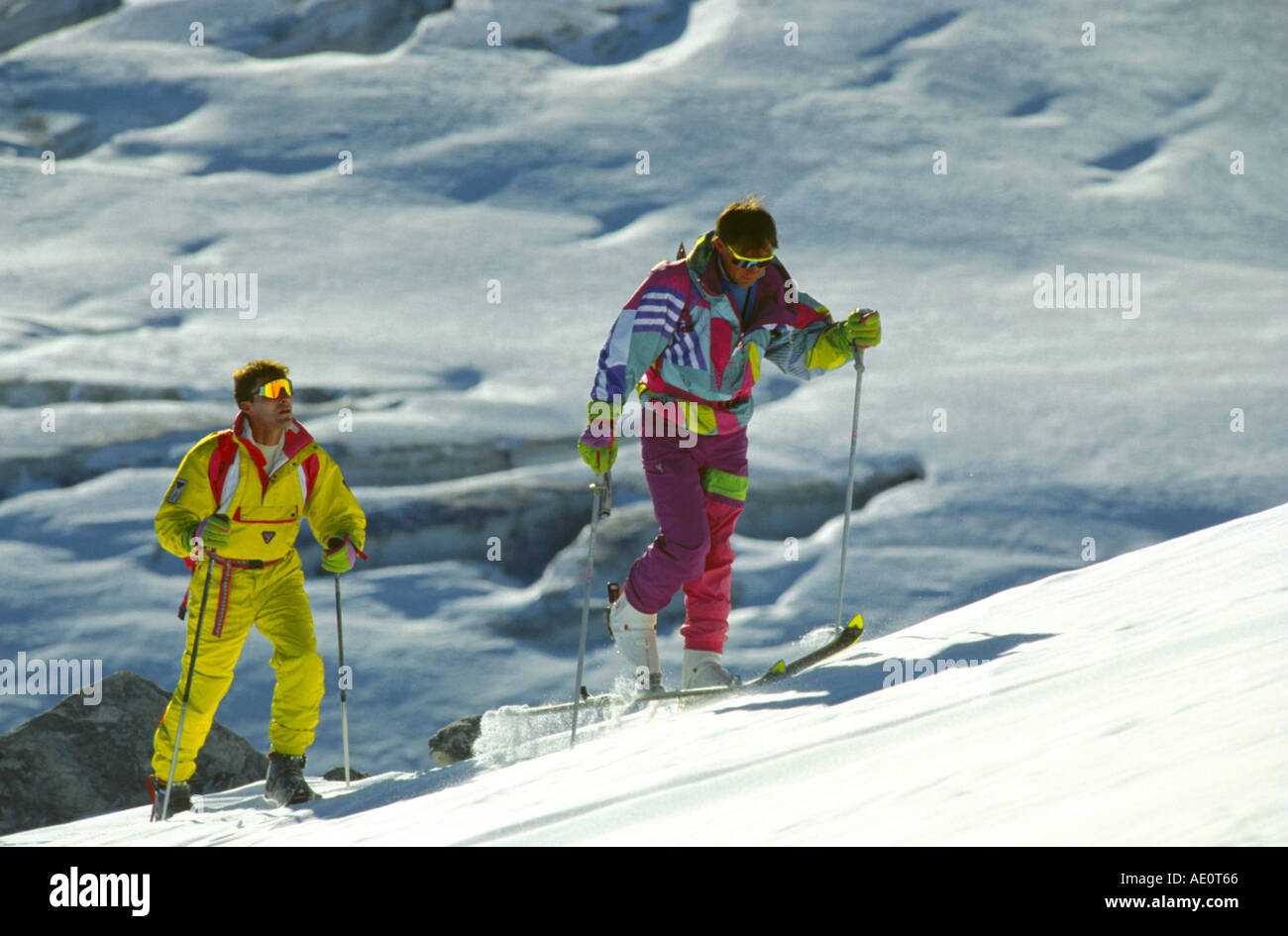 people making alpine ski tour, walking uphill one after the other. Stock Photo