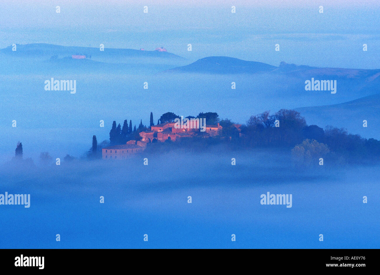typical tuscany hilly landscape with village in morning mist , Italy ...