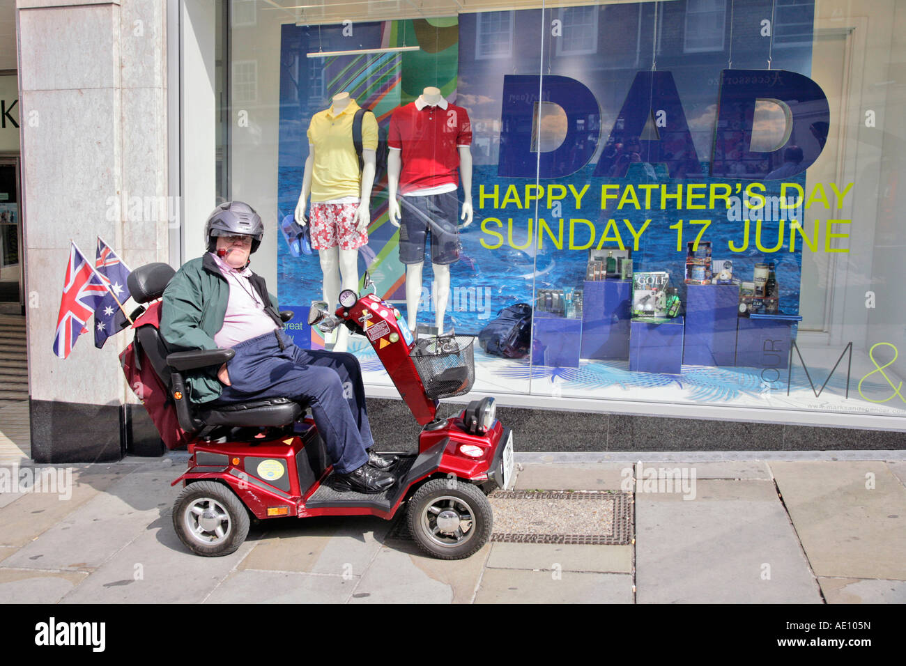 an elderly man lighting his pipe while sitting on a mobility vehicle in