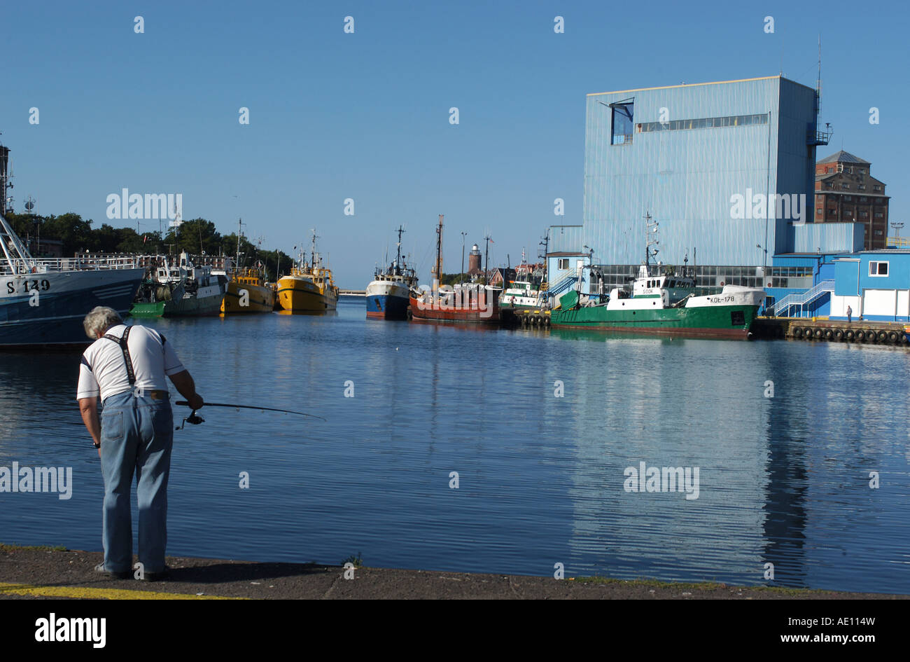 Man fishing in the harbour in Kolobrzeg, Poland Stock Photo