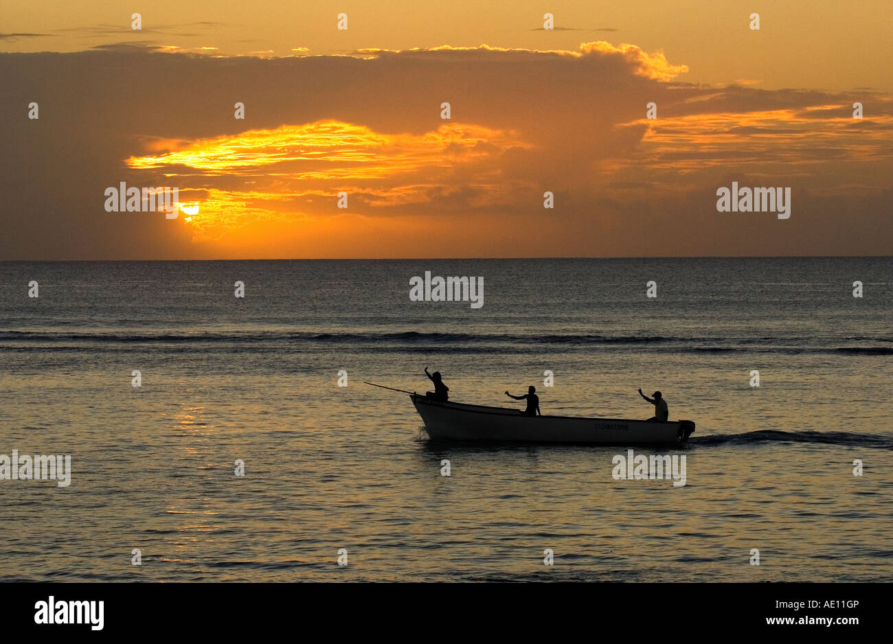 Fishing boat at sunset, Mauritius Stock Photo - Alamy