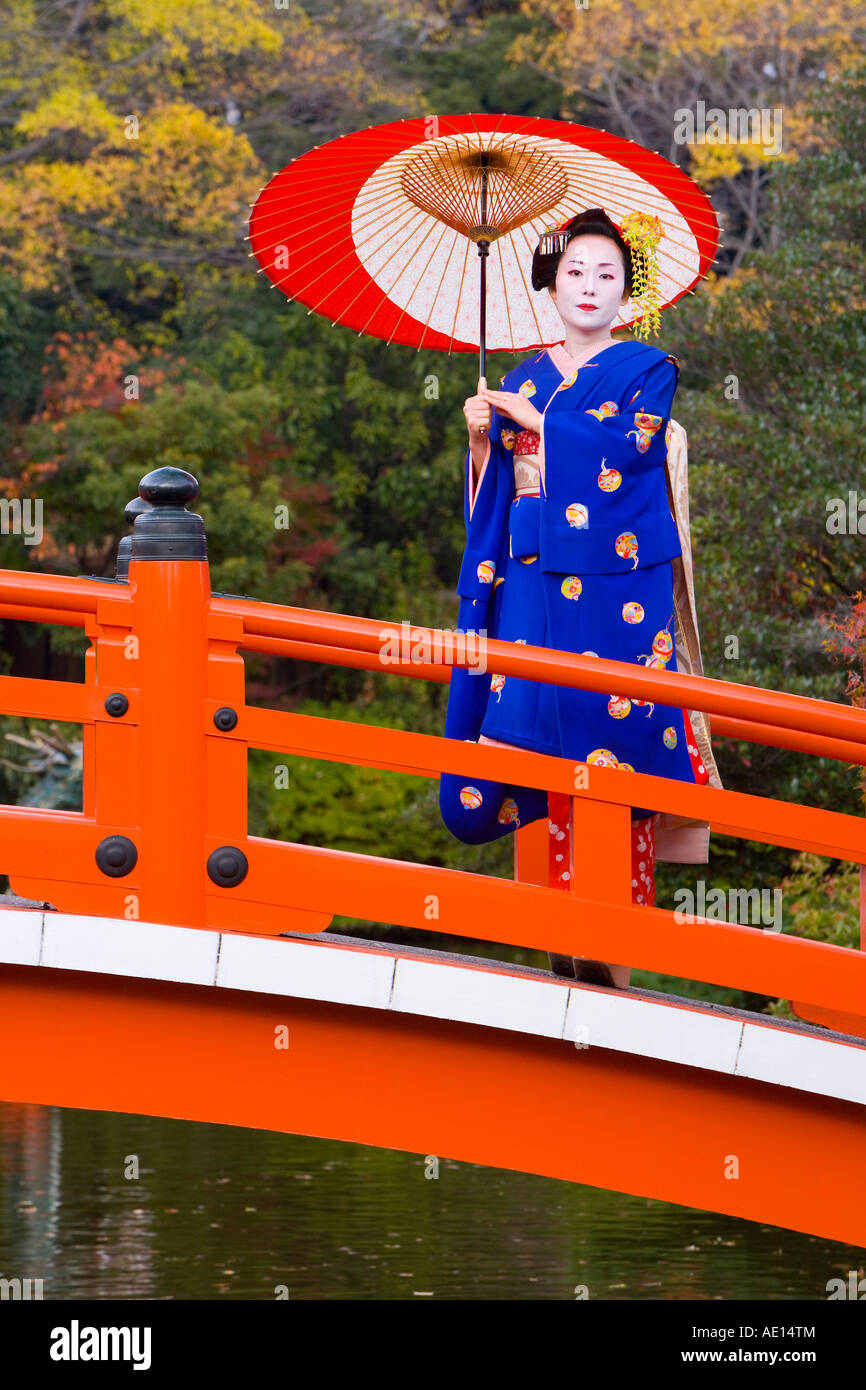 Asia, Japan, Honshu, Kansai Region, Kyoto, Geisha holding an ornate red