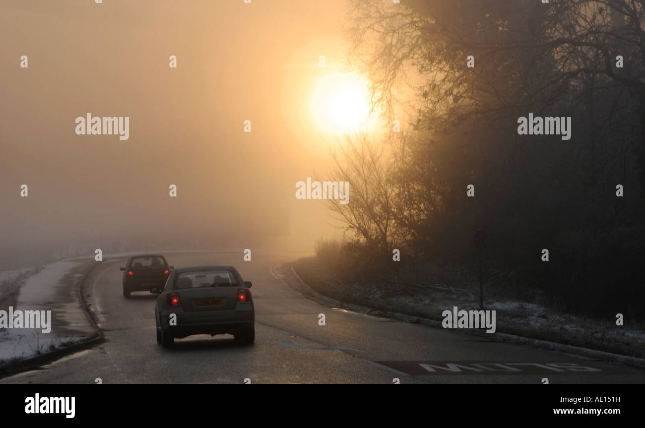 Cars being driven in foggy conditions on a road in the uk Stock Photo