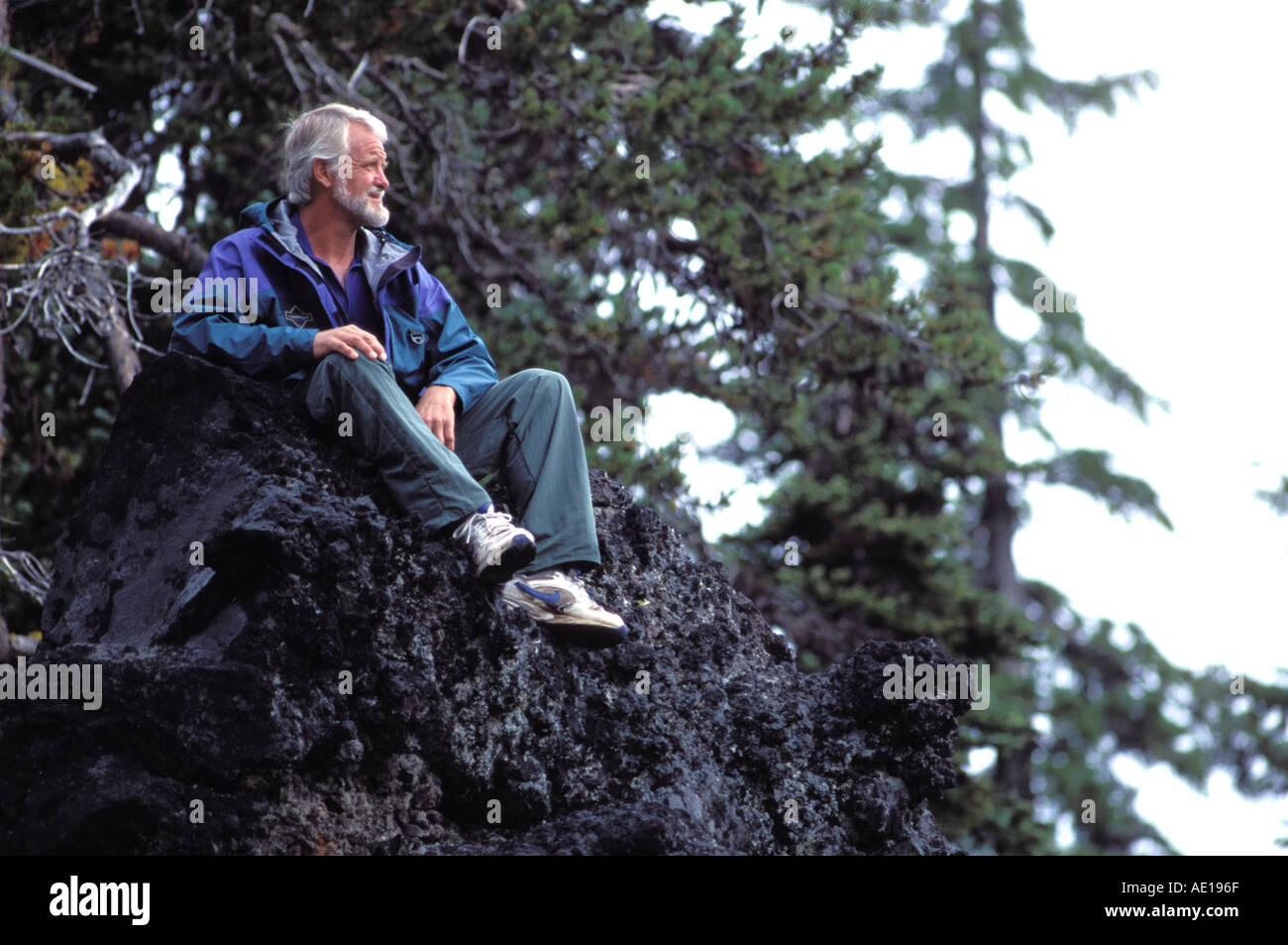 Man sitting in rock hi-res stock photography and images - Alamy