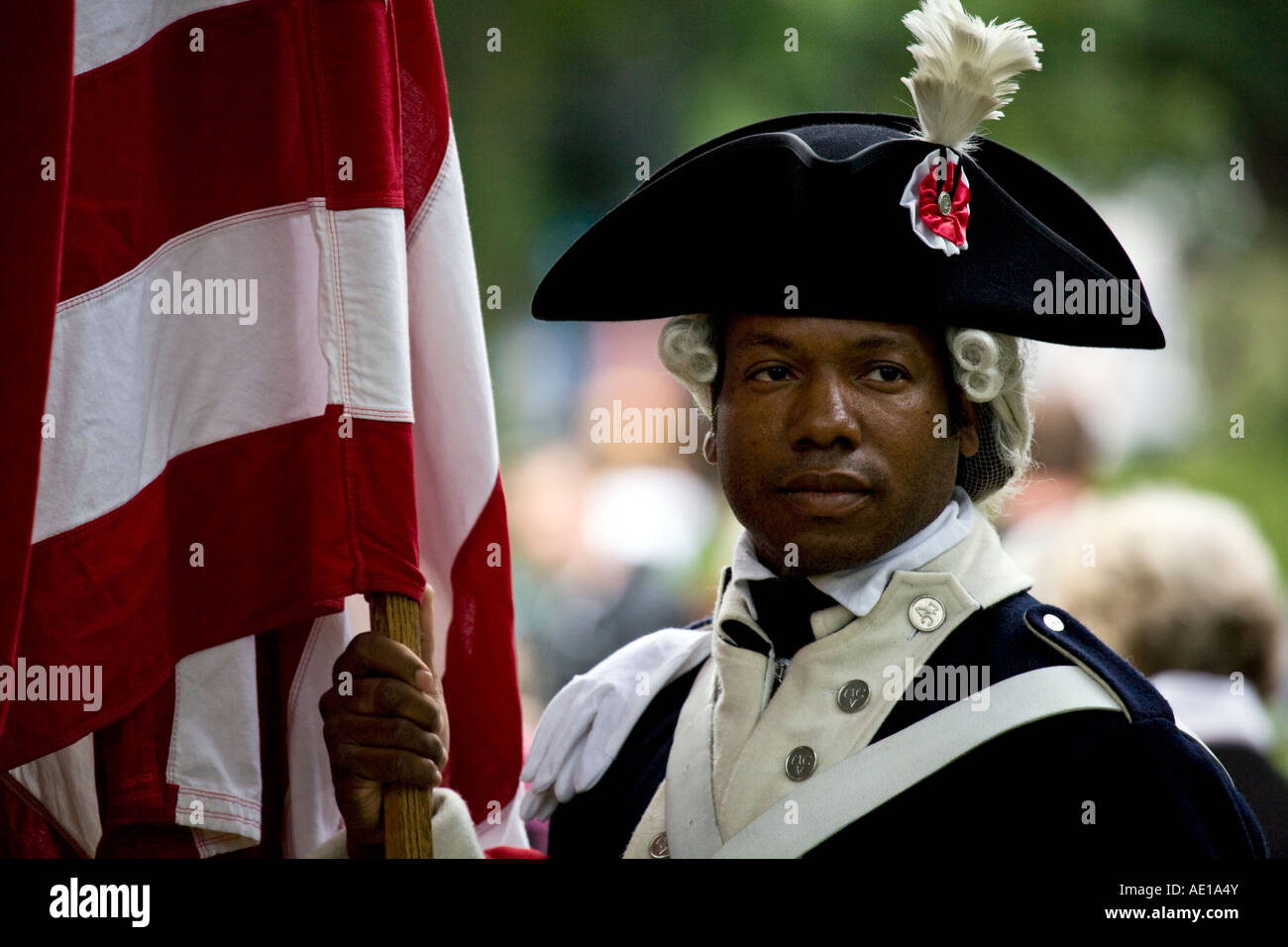 USA flag bearer in period military uniform (circa 1776) at the Edinburgh festival, Scotland. Stock Photo