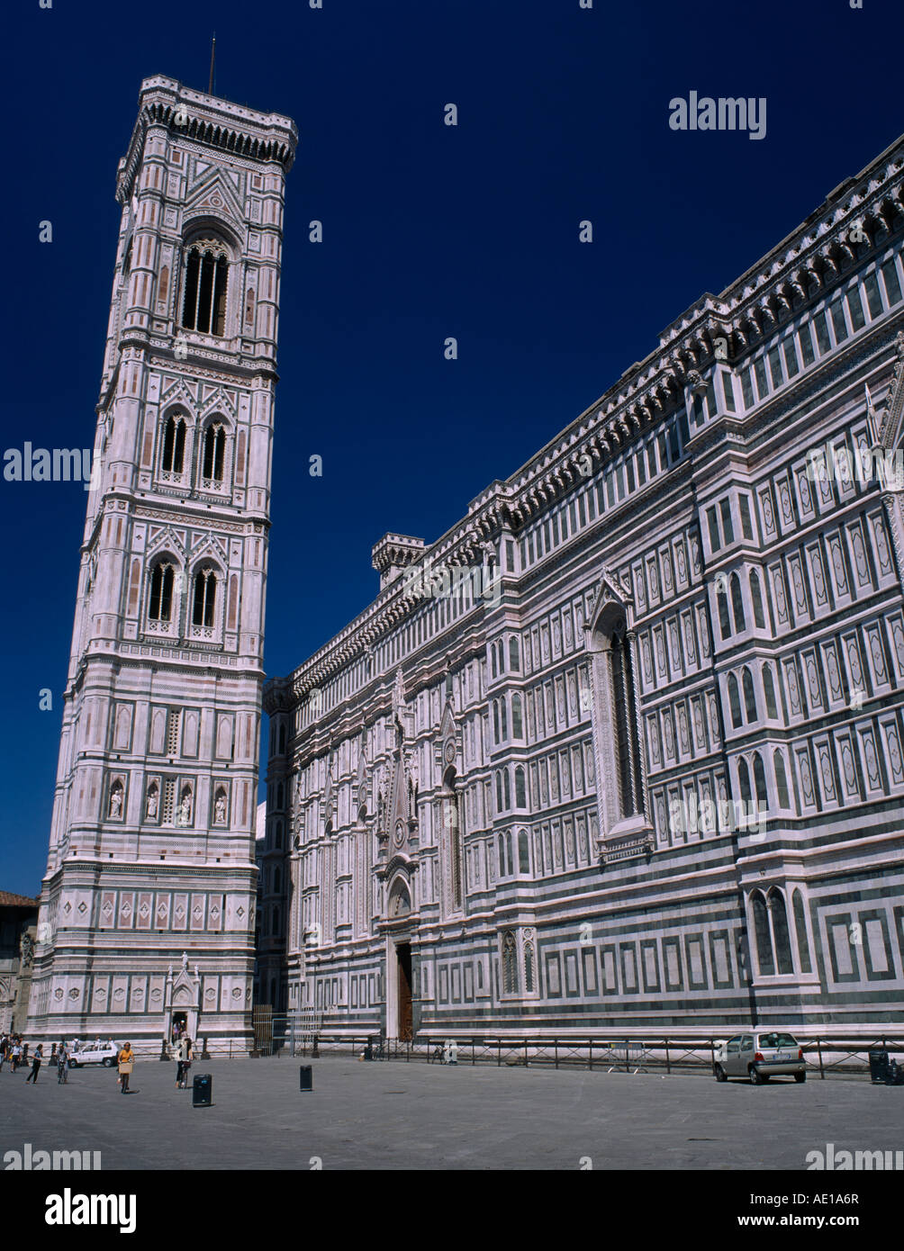 Italy, Tuscany, Florence. The Duomo exterior wall and the Campanile designed by Giotto, and clad in white and coloured marble. Stock Photo
